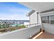 Balcony view of the marina with tile floors, railing, and a cactus against a white exterior wall at 1000 Riverside Dr # B501, Palmetto, FL 34221