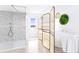 Modern bathroom with a glass-enclosed shower, freestanding tub, and wicker accents at 1000 Riverside Dr # B501, Palmetto, FL 34221