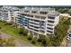 Modern condo building features balconies with nice views of green trees and well-maintained lawn at 1000 Riverside Dr # B501, Palmetto, FL 34221