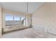 Living room with a view of the water, large windows, and chandelier needing renovation at 1000 Riverside Dr # B501, Palmetto, FL 34221