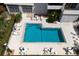 An aerial view of a sparkling pool surrounded by lounge chairs, tables, and lush landscaping at 1000 Riverside Dr # B501, Palmetto, FL 34221