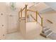 Stairwell of home with light pink walls and wooden railing at 1000 Riverside Dr # B501, Palmetto, FL 34221