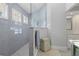 Modern bathroom with tile shower, glass partition, and white shuttered windows at 1016 91St Nw St, Bradenton, FL 34209