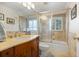 Bathroom features a vanity, bathtub and tiled shower with glass doors at 1016 91St Nw St, Bradenton, FL 34209