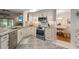 Corner view of kitchen with stainless steel oven and backsplash, plus view of dining area at 1016 91St Nw St, Bradenton, FL 34209