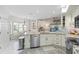 Well-lit kitchen showcasing stainless steel appliances, granite countertops, and seamless flow to dining area at 1016 91St Nw St, Bradenton, FL 34209