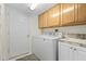 Utility room features a washer, dryer, overhead cabinets, and a sink at 1016 91St Nw St, Bradenton, FL 34209