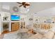 Bright and open living room with a ceiling fan, staircase, and seamless access to the kitchen at 1016 91St Nw St, Bradenton, FL 34209
