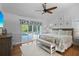 Inviting bedroom featuring ample space, a ceiling fan, hardwood floors, and patio door at 1016 91St Nw St, Bradenton, FL 34209