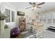 Bright home office with built-in shelving, a large desk, and natural light from shuttered windows at 1016 91St Nw St, Bradenton, FL 34209