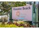 Manatee Beach sign on a sunny day, surrounded by tropical foliage at 1016 91St Nw St, Bradenton, FL 34209