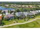 An aerial view of beautiful homes near golf course and waterfront, surrounded by lush landscaping and pools at 10411 Winding Stream Way, Bradenton, FL 34212