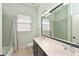 Well-lit bathroom featuring a double sink vanity, a tub with shower, and a large mirror at 10411 Winding Stream Way, Bradenton, FL 34212