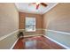Bedroom boasts hardwood floors, crown molding, grasscloth wallpaper and a sunlit window at 10411 Winding Stream Way, Bradenton, FL 34212