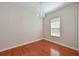 Cozy bedroom with hardwood floors, a window, and a chandelier at 10411 Winding Stream Way, Bradenton, FL 34212
