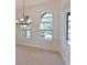 Bright dining room features high ceilings, arched doorways, decorative columns, neutral carpeting and bright windows at 10411 Winding Stream Way, Bradenton, FL 34212