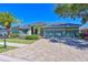Charming home features a well-manicured lawn, lush landscaping, and a long driveway leading to a 3 car garage at 10411 Winding Stream Way, Bradenton, FL 34212