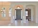 Bright Foyer features high ceilings, arched doorways, decorative columns, and tile flooring at 10411 Winding Stream Way, Bradenton, FL 34212