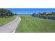 Picturesque view of the golf course, waterfront, and meticulously maintained grounds from the backyard at 10411 Winding Stream Way, Bradenton, FL 34212