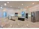 Spacious kitchen boasts granite countertops, stainless steel appliances, and sleek white cabinetry at 10411 Winding Stream Way, Bradenton, FL 34212