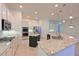 Bright kitchen with stainless steel appliances, granite countertops, and a center island at 10411 Winding Stream Way, Bradenton, FL 34212