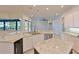Open kitchen with granite countertops, stainless steel appliances, and views of the pool at 10411 Winding Stream Way, Bradenton, FL 34212