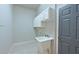 Functional laundry room with white cabinets, sink, and ample space at 10411 Winding Stream Way, Bradenton, FL 34212