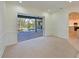 Bright living room opens to the screened-in patio and pool area, offering seamless indoor-outdoor living at 10411 Winding Stream Way, Bradenton, FL 34212