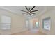 Spacious living room with carpeting, tray ceilings, a decorative ceiling fan, and large windows at 10411 Winding Stream Way, Bradenton, FL 34212