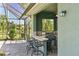 Outdoor kitchen features a built-in grill, bar seating, and views of the water and tropical landscaping at 10411 Winding Stream Way, Bradenton, FL 34212