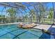 Enclosed pool with rock waterfall hot tub and spacious paved deck, perfect for entertaining at 10411 Winding Stream Way, Bradenton, FL 34212
