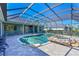 The backyard offers a screened in pool with a rock waterfall hot tub and ample space for entertaining at 10411 Winding Stream Way, Bradenton, FL 34212