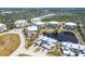 Aerial view of condo community, showing well-maintained landscaping, water features, and multiple buildings at 10720 Lemon Creek Loop # 103, Englewood, FL 34224