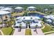 Aerial view of the community showcases the pond, landscaping, and the exterior architecture at 10720 Lemon Creek Loop # 103, Englewood, FL 34224