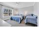 Bright bedroom with two beds, large window for natural light, and neutral tones at 10720 Lemon Creek Loop # 103, Englewood, FL 34224