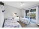 Comfortable bedroom with twin beds and lanai access overlooking a serene water view at 10720 Lemon Creek Loop # 103, Englewood, FL 34224