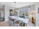 Bright dining room with a large window and ample seating for entertaining at 10720 Lemon Creek Loop # 103, Englewood, FL 34224