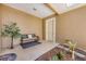 Inviting entryway with bench, plants, and a neutral color scheme, leading to the front door at 10720 Lemon Creek Loop # 103, Englewood, FL 34224