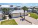 Exterior view of the unit featuring a two car garage and clean landscape at 10720 Lemon Creek Loop # 103, Englewood, FL 34224
