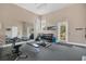 Bright community gym with free weights, weight bench, exercise bike, and wall-to-wall mirrors at 10720 Lemon Creek Loop # 103, Englewood, FL 34224