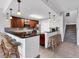 Kitchen with dark cabinets, stainless steel appliances, and a breakfast bar with seating at 10720 Lemon Creek Loop # 103, Englewood, FL 34224
