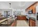 Spacious kitchen with dark cabinets, stainless steel appliances, and an open bar area overlooking the backyard at 10720 Lemon Creek Loop # 103, Englewood, FL 34224