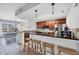 Open kitchen with breakfast bar, stainless steel appliances, and adjacent dining area at 10720 Lemon Creek Loop # 103, Englewood, FL 34224