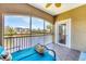 Relax and enjoy serene water views from this private lanai with a comfortable seating area at 10720 Lemon Creek Loop # 103, Englewood, FL 34224