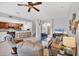 Cozy living room with tile floors, comfortable seating, and an open view of the kitchen and staircase at 10720 Lemon Creek Loop # 103, Englewood, FL 34224