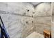 Modern shower featuring tile surround, multiple shower heads, and a built-in niche for storage at 10720 Lemon Creek Loop # 103, Englewood, FL 34224