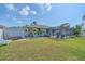 Expansive back yard with pool, screened lanai, shed, and lush green lawn at 108 Stanford Rd, Venice, FL 34293