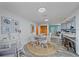 Dining area with a large round rug, and casual seating area with white walls at 108 Stanford Rd, Venice, FL 34293
