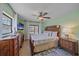 Spacious main bedroom with decorative wood furniture, ceiling fan, and private backyard views at 108 Stanford Rd, Venice, FL 34293