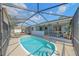 Inviting pool area with screened-in lanai featuring outdoor seating and lounging options at 108 Stanford Rd, Venice, FL 34293